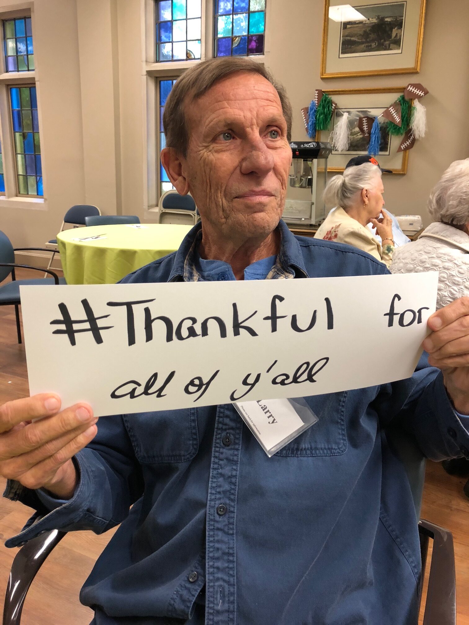 Respite for All friend holding a sign that reads “Thankful for all of y’ll”
