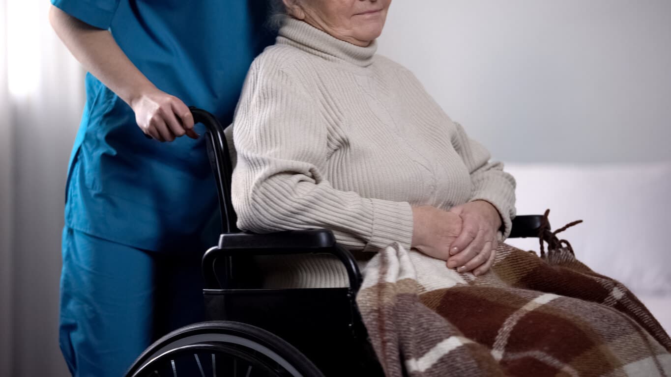 Benefits of respite care – elderly woman in a wheelchair receiving support from a caregiver